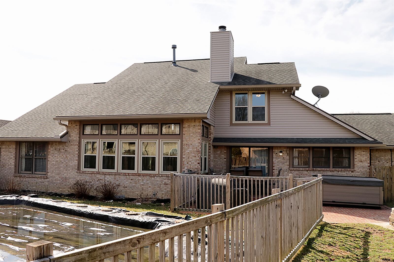 An in-ground swimming pool has an updated liner, motor and sand-filter in 2018. The back yard is surrounded by a wooden privacy fence with a second wood picket fence around the pool. There is a wooden deck and paver-brick patio. CONTRIBUTED PHOTO BY KATHY TYLER