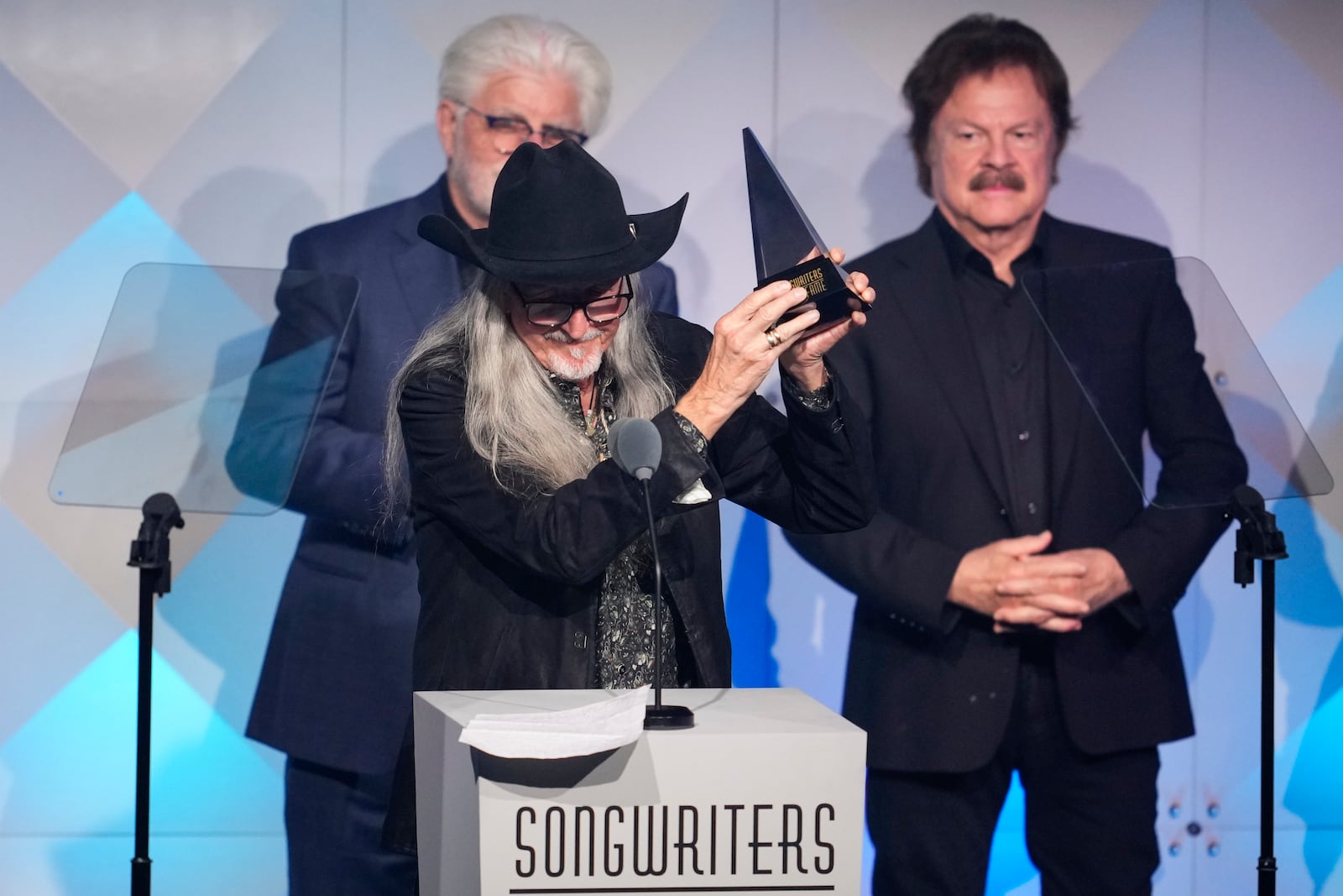 Michael McDonald, from left, Patrick Simmons, and Tom Johnston of The Doobie Brothers accept an award during the 54th annual Songwriters Hall of Fame induction and awards gala on Thursday, June 12, 2025, at the Marriott Marquis Hotel in New York. (Photo by Charles Sykes/Invision/AP)