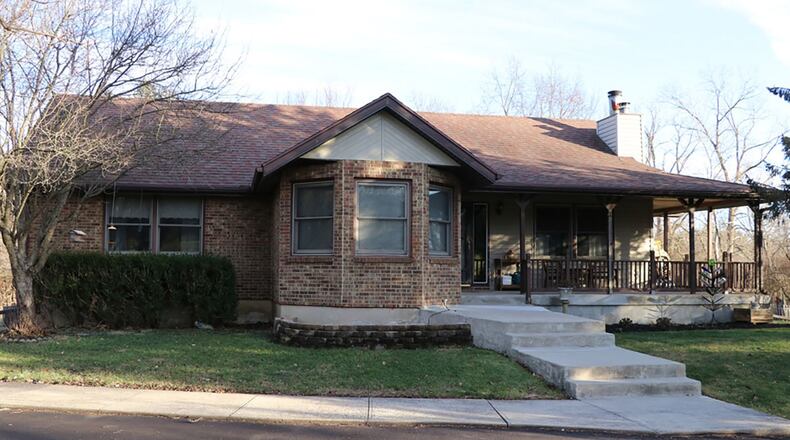 Tucked among the trees at the end of a paved driveway on 3.75 acres, this brick ranch has a wrap-around porch, a versatile floor plan with room to expand. CONTRIBUTED PHOTOS BY KATHY TYLER