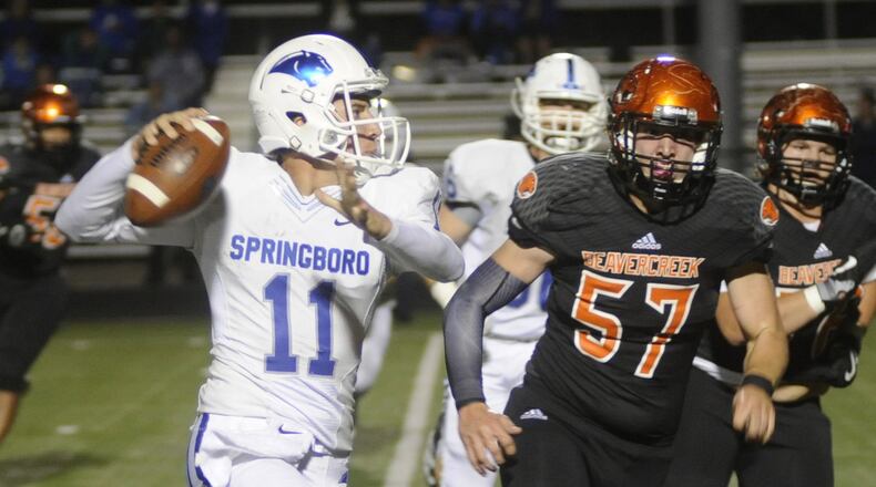 Springboro QB Brody Mahle (left) is pursued by Beavercreek’s Jay Drennen. Springboro defeated Beavercreek 31-28 in a GWOC crossover high school football game at Frank Zink Field on Thursday, Sept. 29, 2016. MARC PENDLETON / STAFF