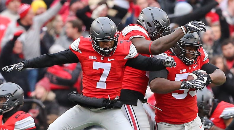 Ohio State Buckeyes defensive tackle Davon Hamilton (53) is congratulated by safety Damon Webb (7) and defensive end Jalyn Holmes (center) following his fumble recovery at the goal line during the third quarter.
