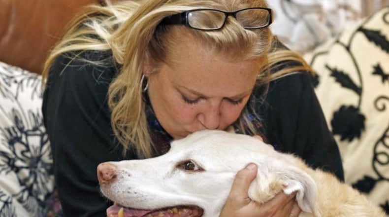 Jennifer Jenkins shows her Labrador mix some love. HANDOUT