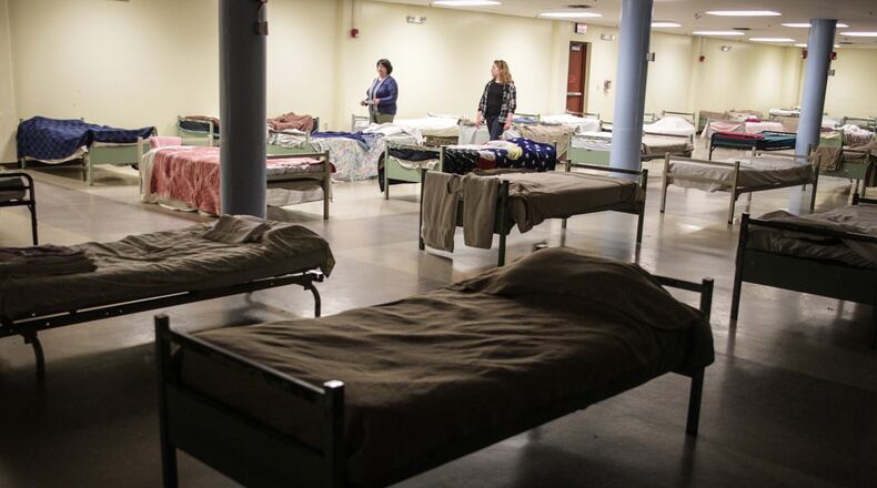 The beds at St. Vincent de Paul homeless shelter on Apple Street in Dayton had to be moved farther apart because of the coronavirus. Almost 100 people had to be moved into local hotels because of coronavirus overcrowding. JIM NOELKER/STAFF