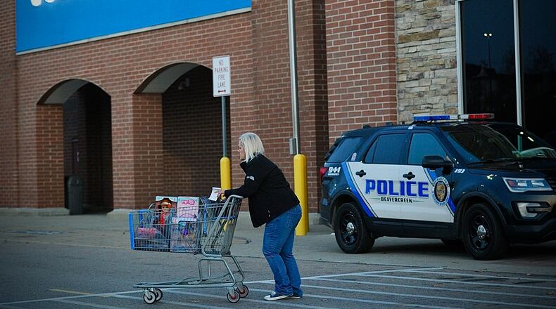 Five police cruisers sit outside the Beavercreek Walmart store on Black Friday, November 24, 2023. The store reopened that morning after a shooting there injured four people earlier in the week. MARSHALL GORBY \STAFF
