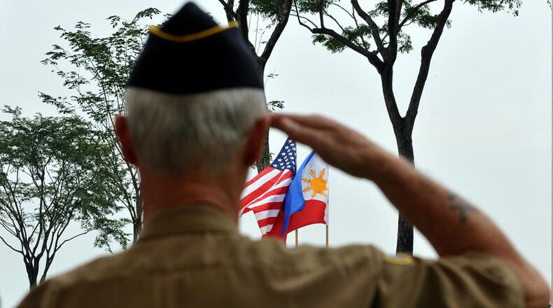 A retired American soldier salutes to the colors during Veterans Day JAY DIRECTO/AFP/Getty Images)