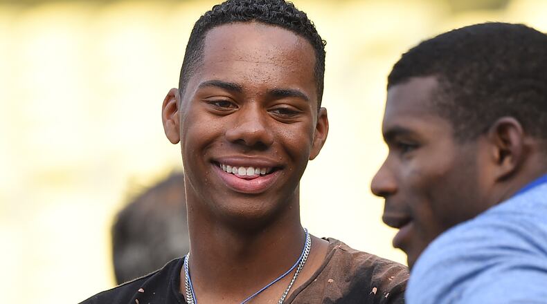 Hunter Greene, from Stevenson Ranch, Calif., talks with right fielder Yasiel Puig of the Dodgers during batting practice before the game against the Phillies at Dodger Stadium on April 28, 2017 in Los Angeles.