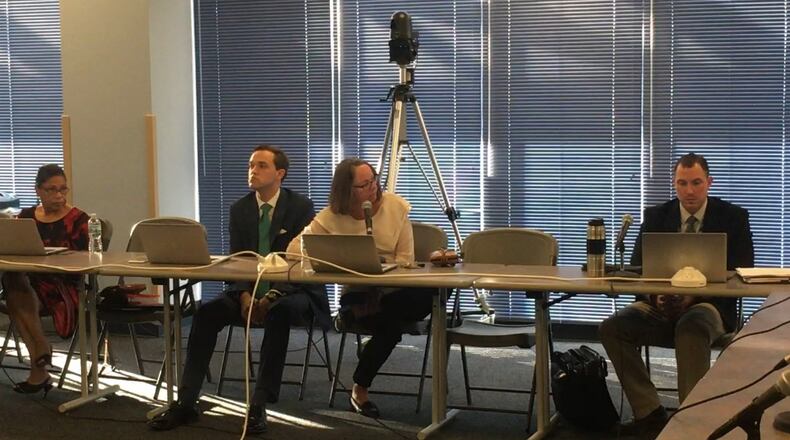 Dayton school board member Sheila Taylor asks a question of DPS internal auditor Randall Harper (right). JEREMY P. KELLEY / STAFF