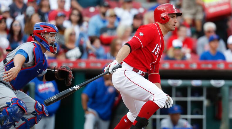 Cincinnati Reds' Joey Votto hits a fielders choice off Chicago Cubs starting pitcher Jon Lester to first to drive in Jose Peraza in the first inning of a baseball game, Saturday, Oct. 1, 2016, in Cincinnati. (AP Photo/John Minchillo)