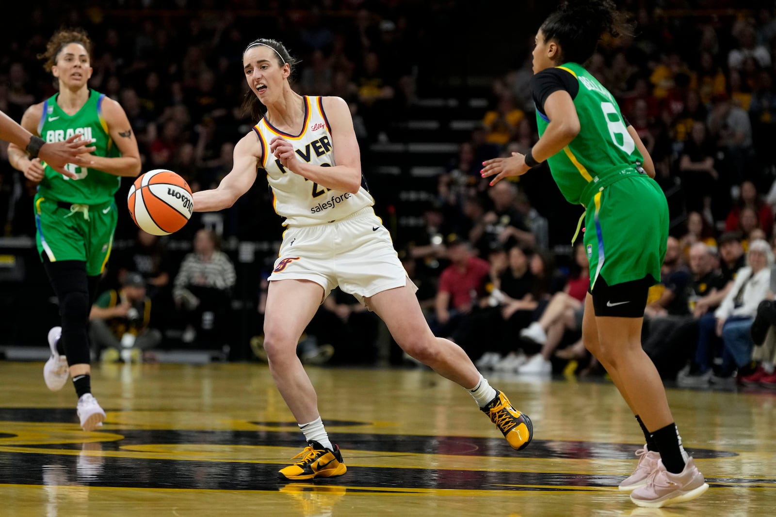 Indiana Fever guard Caitlin Clark, center, passes upcourt during the second half of an exhibition women's basketball game against Brazil, Sunday, May 4, 2025, in Iowa City, Iowa. (AP Photo/Charlie Neibergall)