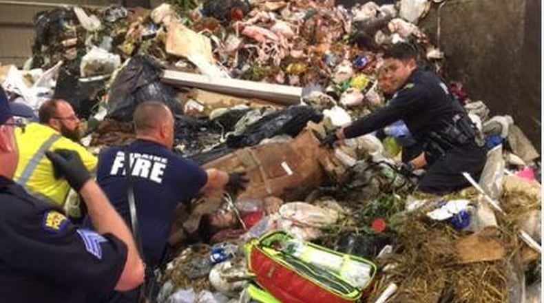 Crews at the Montgomery County Solid Waste Facility in Moraine on Tuesday morning discovered a man buried alive in garbage after a trash truck dumped its load. CONTRIBUTED