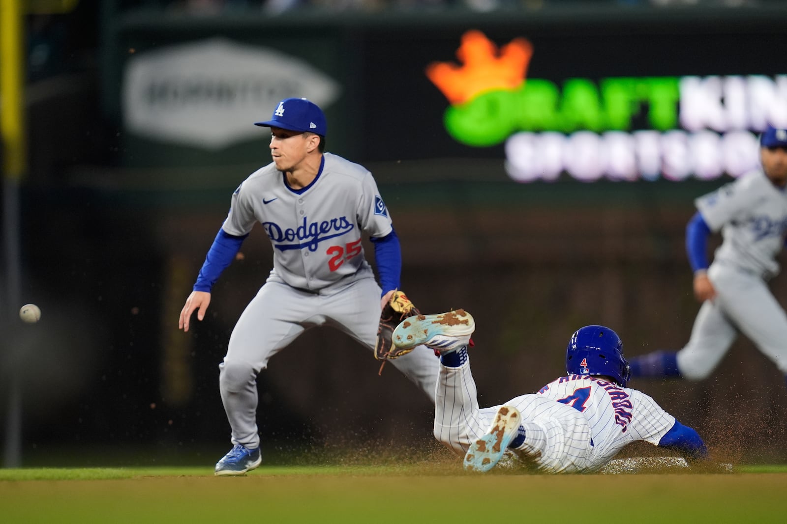 Chicago Cubs' Pete Crow-Armstrong (4), right, steals second base by Los Angeles Dodgers second baseman Tommy Edman (25) during the fifth inning of a baseball game against the Los Angeles Dodgers, Wednesday, April 23, 2025, in Chicago. (AP Photo/Erin Hooley)