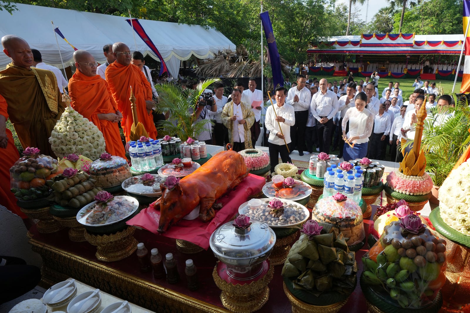 Cambodian town hall officers offer prayer at a ceremony during an annual of Remembrance Day at Choeung Ek, a former Khmer Rouge "killing field," on the outskirt of Phnom Penh, Cambodia Tuesday, May 20, 2025. (AP Photo/Heng Sinith)