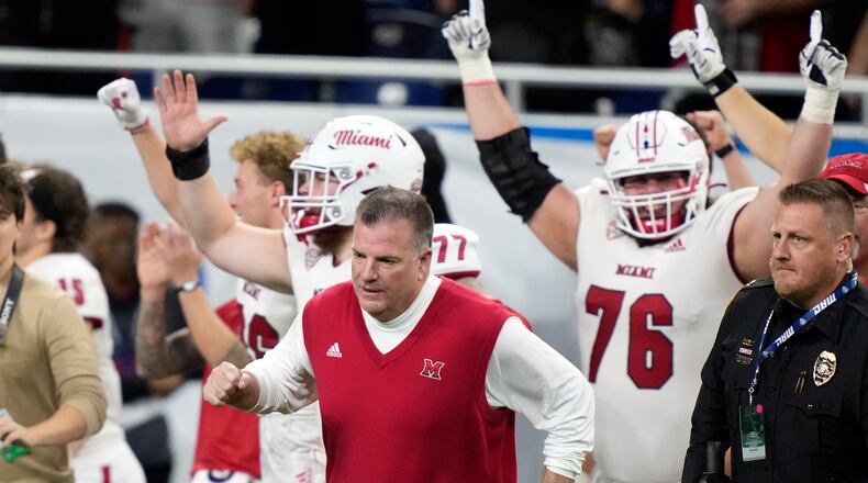 Miami (Ohio) head coach Chuck Martin runs onto the field after the Mid-American Conference championship NCAA college football game against Toledo, Saturday, Dec. 2, 2023, in Detroit. (AP Photo/Carlos Osorio)