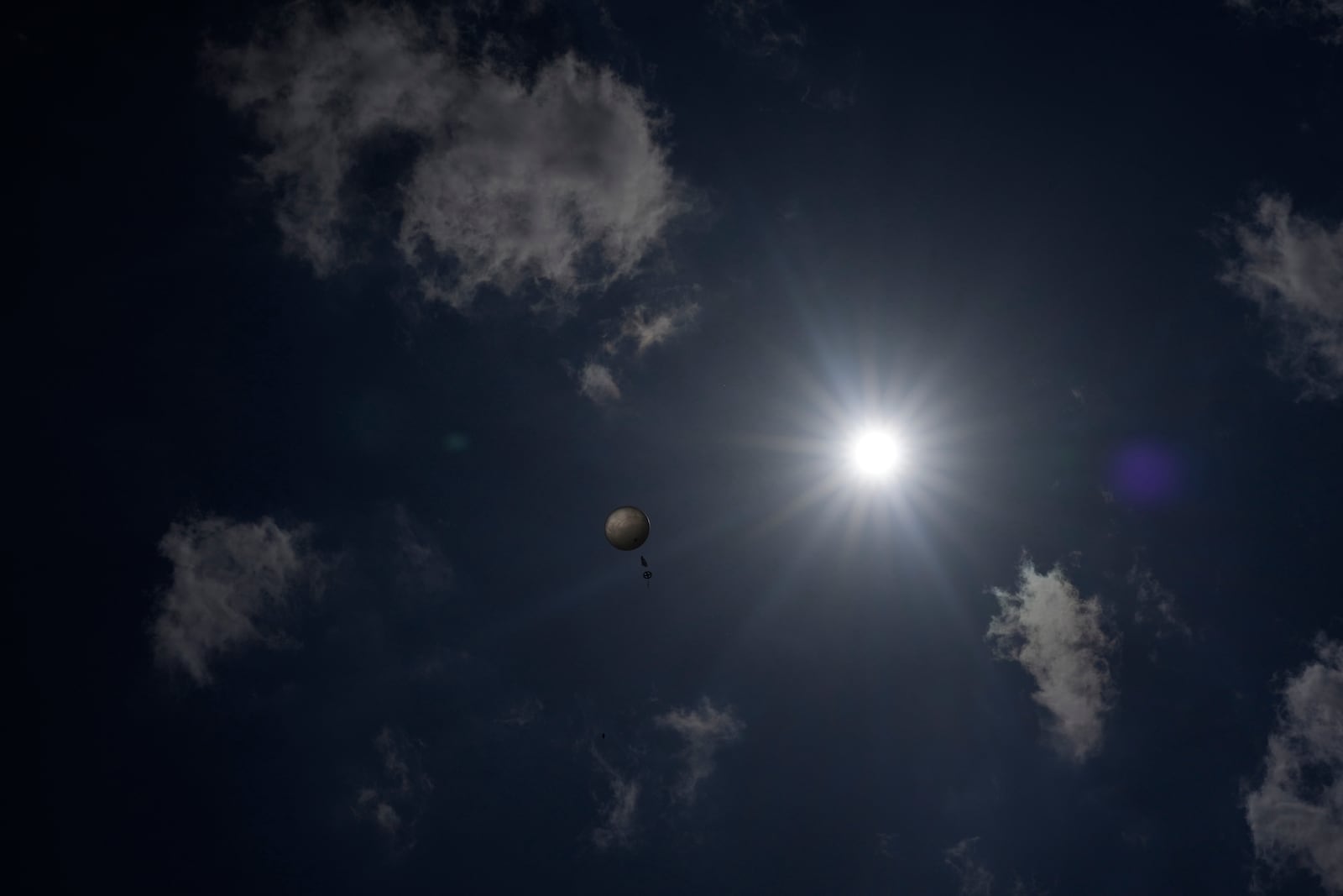 A weather balloon soars in the sky that was released by members of Project ICECHIP's black team to collect data Friday, June 6, 2025, in Morton, Texas. (AP Photo/Carolyn Kaster)