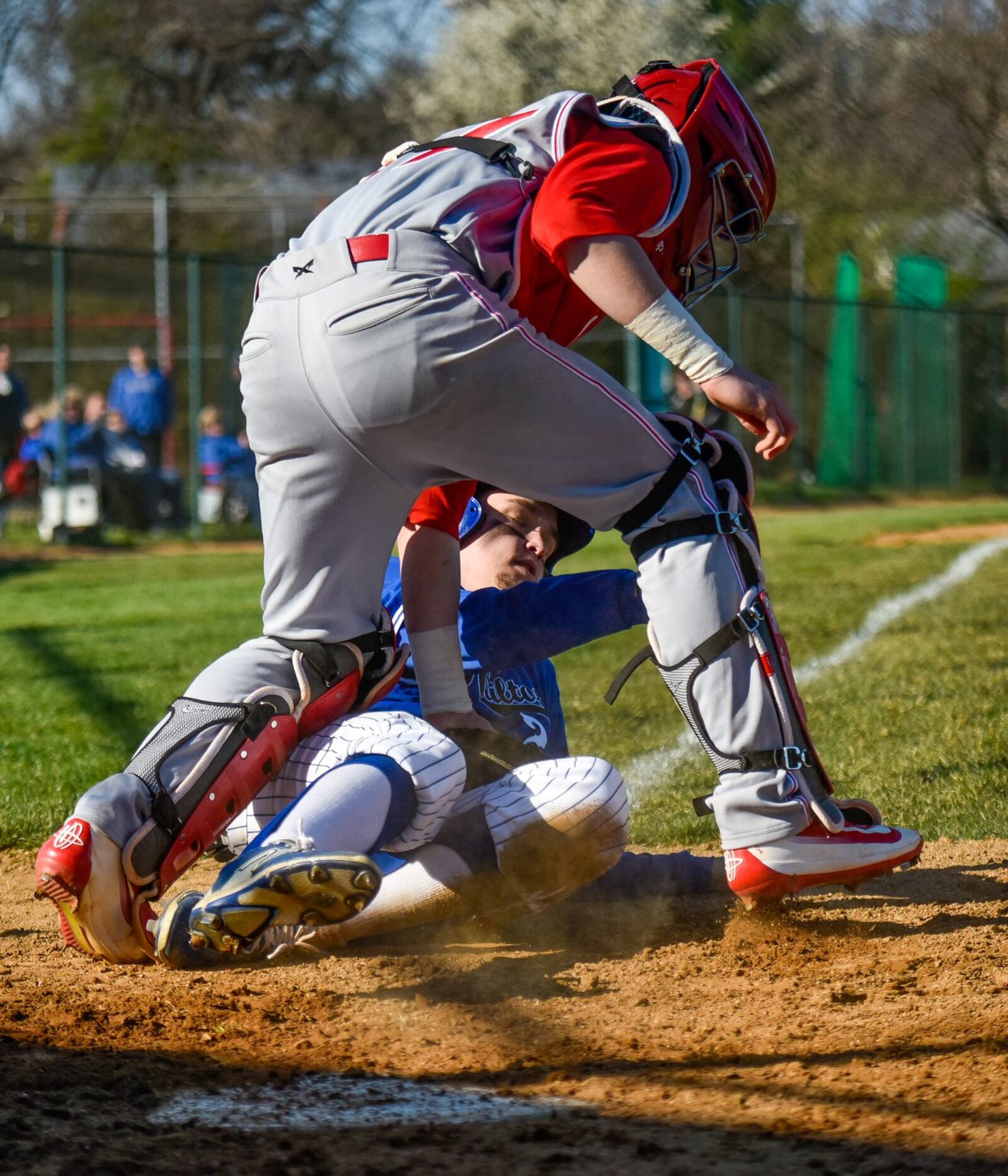 Lakota West’s Keegan Fish tags out Hamilton’s Jordan Wilke at home plate during the Firebirds’ 3-2 win on March 29, 2016, at Hamilton. NICK GRAHAM/STAFF