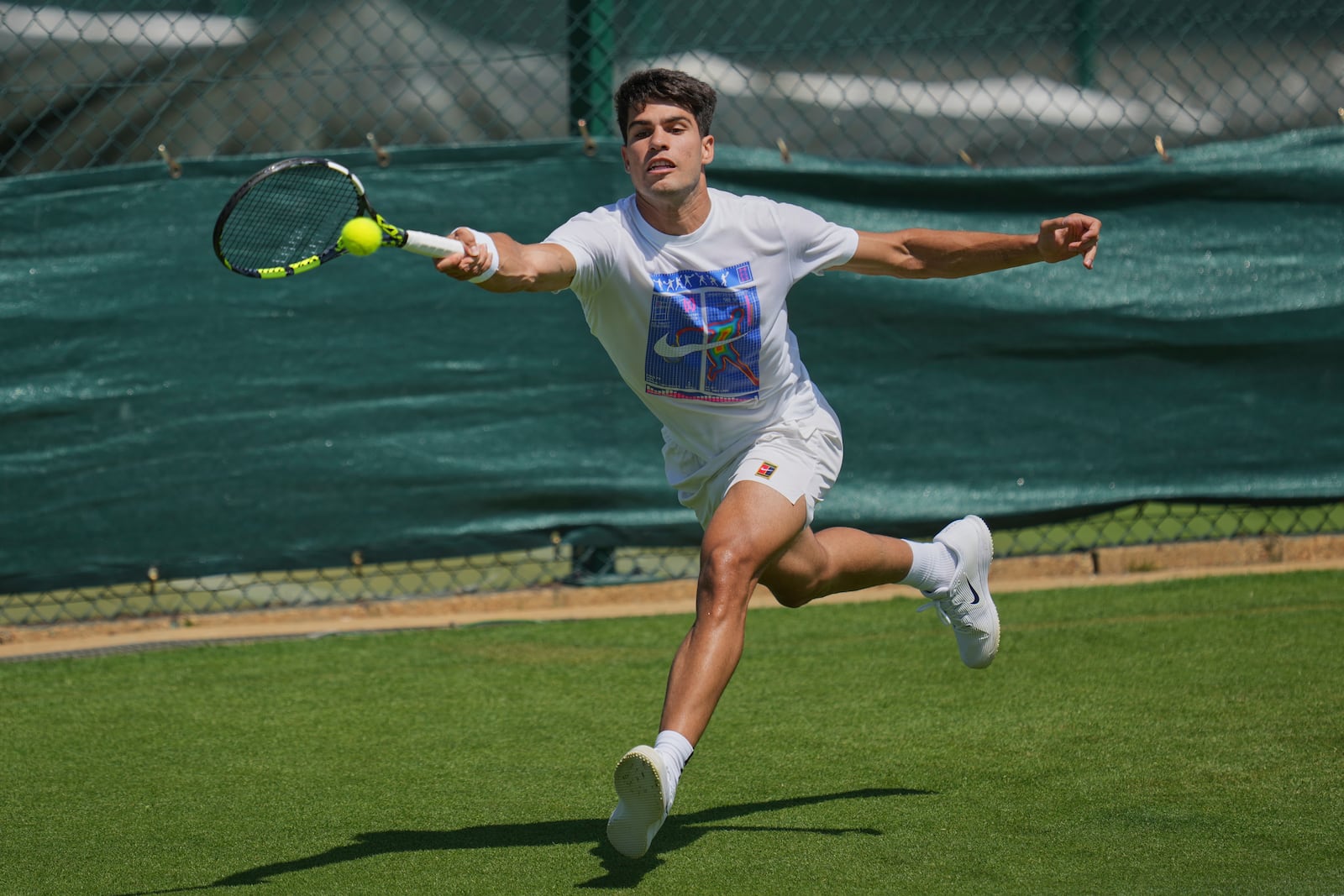 Carlos Alcaraz of Spain plays a return during a practice session ahead of the Wimbledon Championships in London, Friday, June 27, 2025. (AP Photo/Kin Cheung)