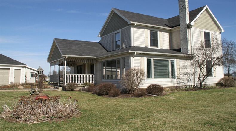 The fish-scale and vinyl-sided, 2-story residence is one of 4 buildings on the 25.4-acre property located within Concord Twp. Formal entry to the house is from a covered porch that is on the side facing the pond.