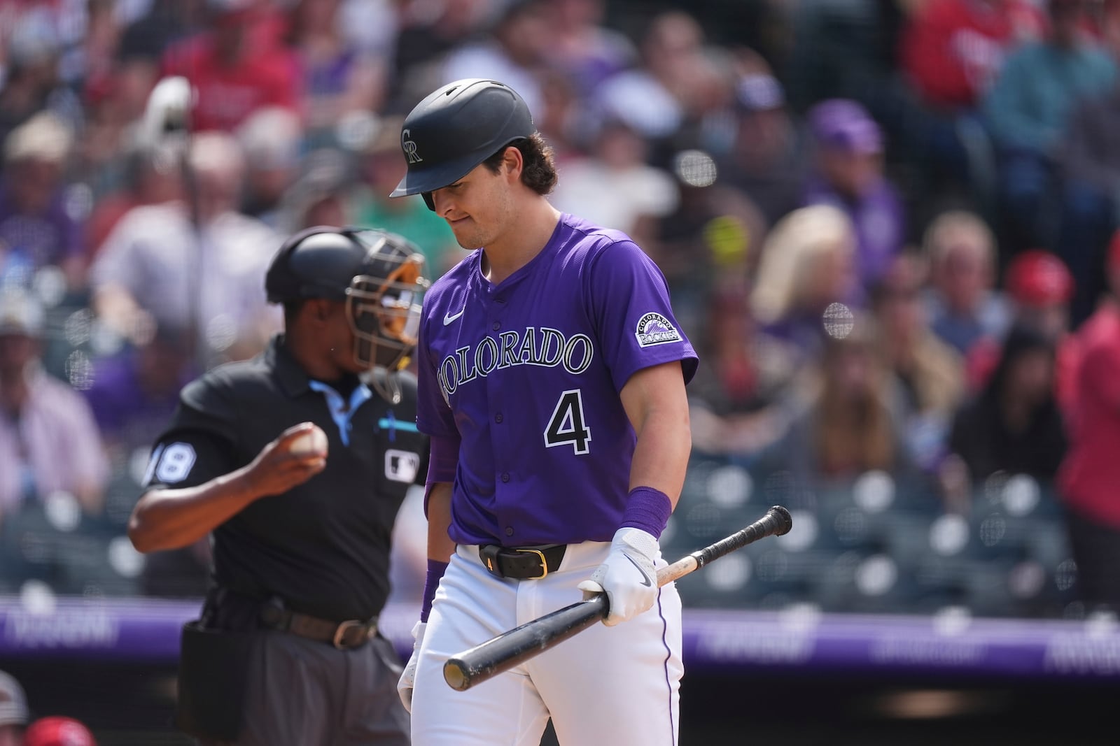 Colorado Rockies' Michael Toglia reacts after striking out against Cincinnati Reds relief pitcher Alexis Díaz to end the eighth inning of a baseball game Saturday, April 26, 2025, in Denver. (AP Photo/David Zalubowski)