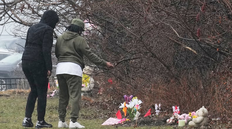 People visit a memorial at the site where two girls bodies were found earlier this week, in Cleveland, Thursday, March 5, 2026. (AP Photo/Sue Ogrocki)