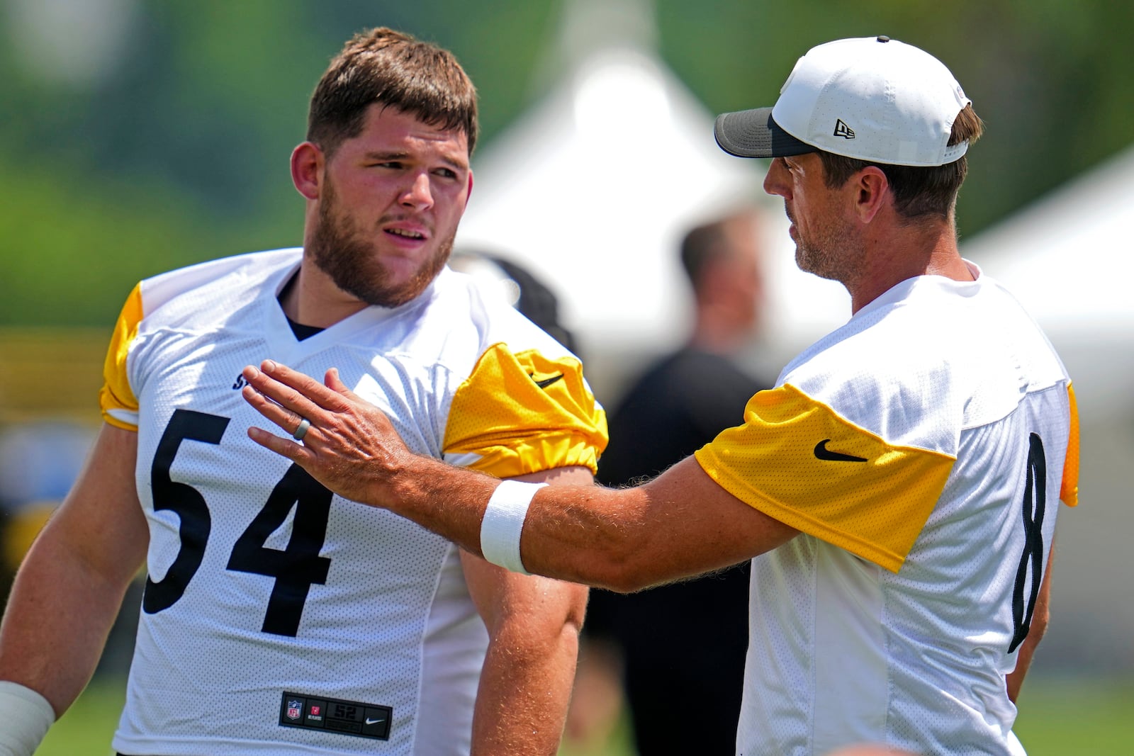 Pittsburgh Steelers quarterback Aaron Rodgers, right, talks with center Zach Frazier (54) during the NFL football team's training camp workout in Latrobe, Pa., Wednesday, July 23, 2025. (AP Photo/Gene J. Puskar)