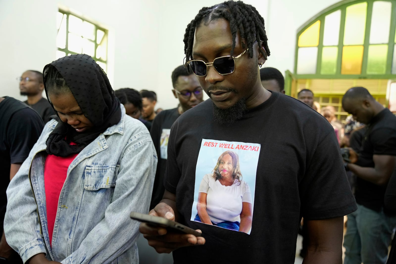 Mourners sing during the funeral service of Nigerian Ladi Anzaki Olubunmi, a TikTok content moderator employed by subcontractor Teleperformance, at Chiromo Funeral Parlour in Nairobi, Kenya Thursday, April. 17, 2025. (AP Photo/Brian Inganga)