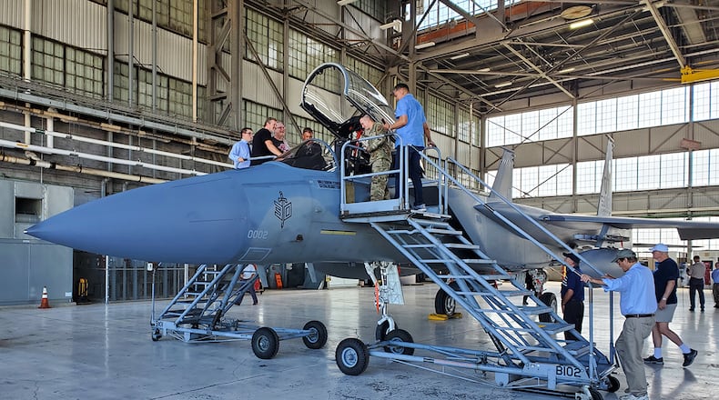 Members of the F-15 Program Office check out an F-15 aircraft during a ceremony on July 28 to mark 50 years of flight. U.S. AIR FORCE PHOTO/BRIAN BRACKENS