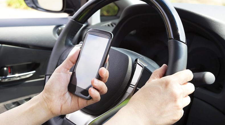 Checking Facebook, sending snapchats, tweeting or otherwise getting distracted while driving could get expensive in Ohio. Getty Image
