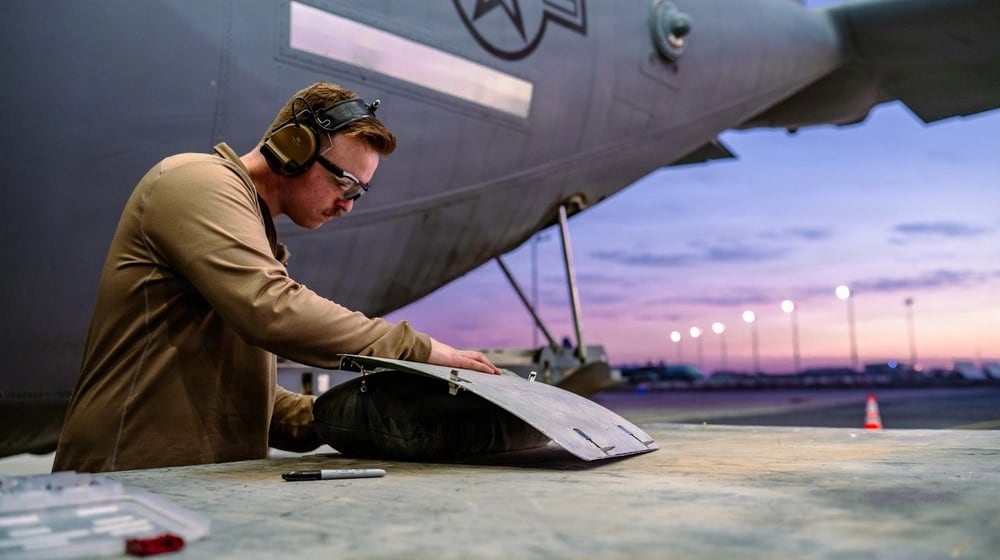 Air Force Staff Sgt. Andrew Pokojski, 61st Expeditionary Aircraft Maintenance Squadron aircraft structural maintenance technician, shapes a replacement panel on a C-130J Super Hercules within the U.S. Central Command area of responsibility, Jan. 5, 2026. Air Force photo by Staff Sgt. Tylin Rust