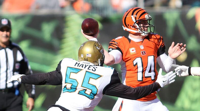 CINCINNATI, OH - NOVEMBER 2: Andy Dalton #14 of the Cincinnati Bengals throws a pass as Geno Hayes #55 of the Jacksonville Jaguars applies pressure during the second quarter at Paul Brown Stadium on November 2, 2014 in Cincinnati, Ohio. (Photo by John Grieshop/Getty Images)