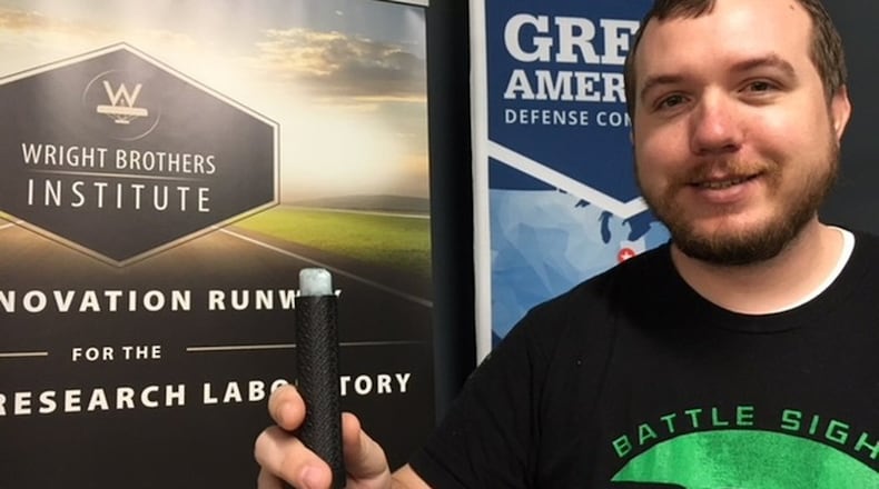 Nicholas Ripplinger, president of Battle Sight Technologies LLC, holding the implement that can leave writing and marks visible only to warfighters and first-responders who have certain night vision goggles. Battle Sight earlier this year won a Soin Award for Innovation and is already bringing in revenue from customers who value the company s technology. THOMAS GNAU/STAFF