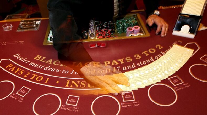 A dealer shuffles cards at a blackjack table at the Hollywood Columbus casino. The casino had its worth November, revenue-wise, since opening in October 2012. FILE PHOTO