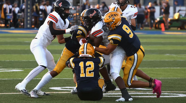 Springfield tackles Beavercreek's Quentin Youngblood on Friday, Sept. 15, 2023, in Springfield. David Jablonski/Staff