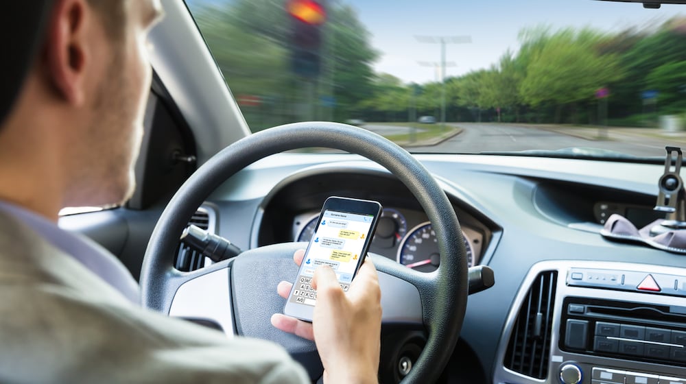 While it's illegal to use a phone while driving in Ohio, many are still looking at it at stoplights and while waiting on trains. ISTOCK
