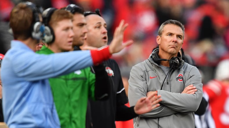 COLUMBUS, OH - NOVEMBER 11:  Head Coach Urban Meyer of the Ohio State Buckeyes looks up at the scoreboard as his coaches send in plays in the fourth quarter against the Michigan State Spartans at Ohio Stadium on November 11, 2017 in Columbus, Ohio. Ohio State defeated Michigan State 48-3.  (Photo by Jamie Sabau/Getty Images)
