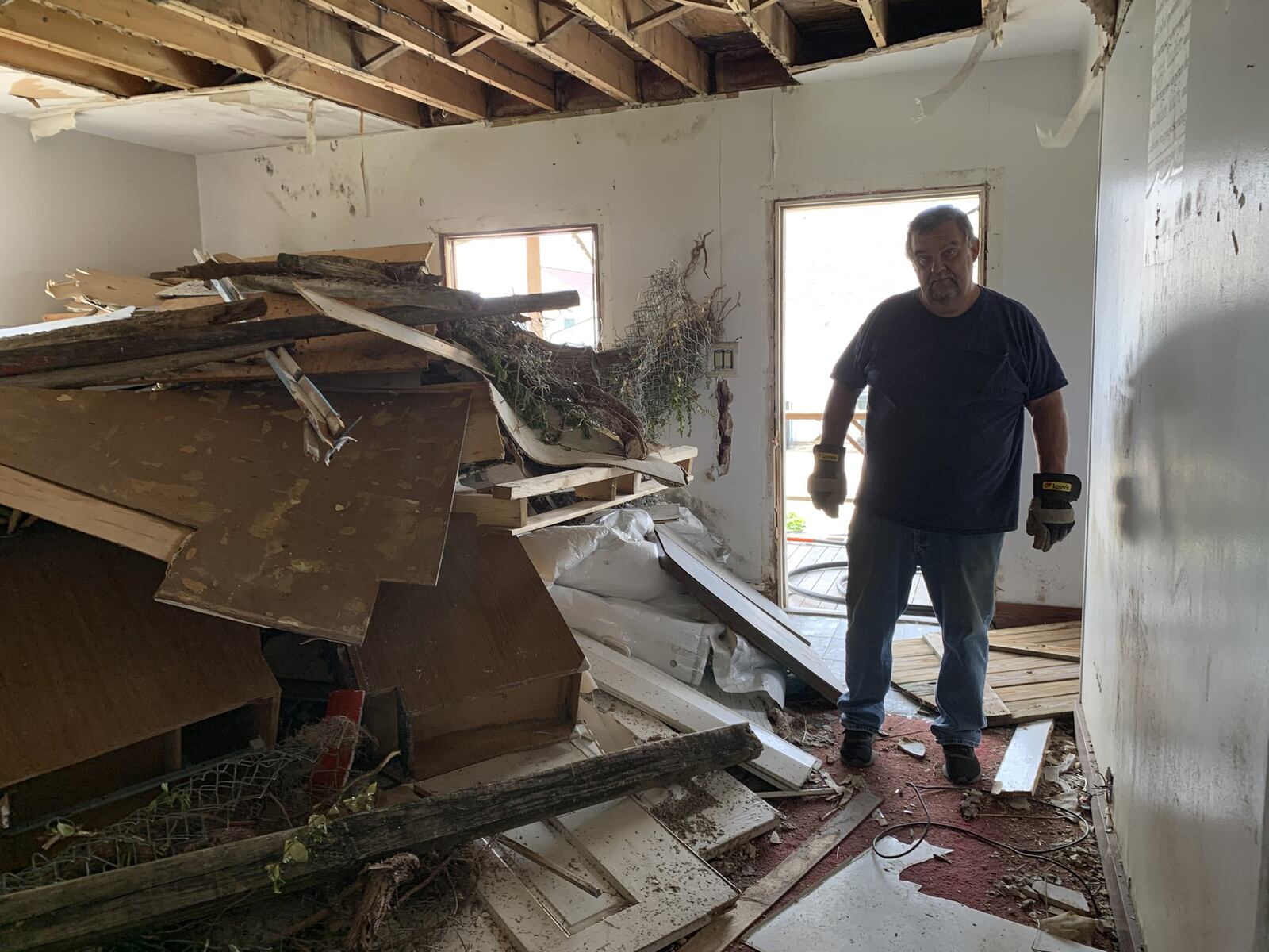 Mushrooms grow in what used to be Mike Horn s living room, piled with debris from the collapsed second floor. He hopes to have the house torn down this month so he can rebuild from the Memorial Day 2019 tornadoes.
