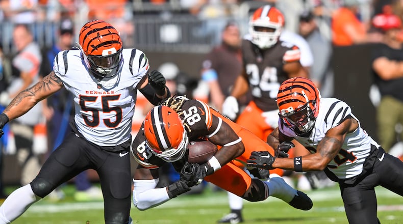 Cleveland Browns tight end David Njoku (85) is brought down by Cincinnati Bengals safety Vonn Bell and linebacker Logan Wilson (55) on a pass reception in the first half of an NFL football game, Sunday, Oct. 20, 2024, in Cleveland. (AP Photo/David Richard)