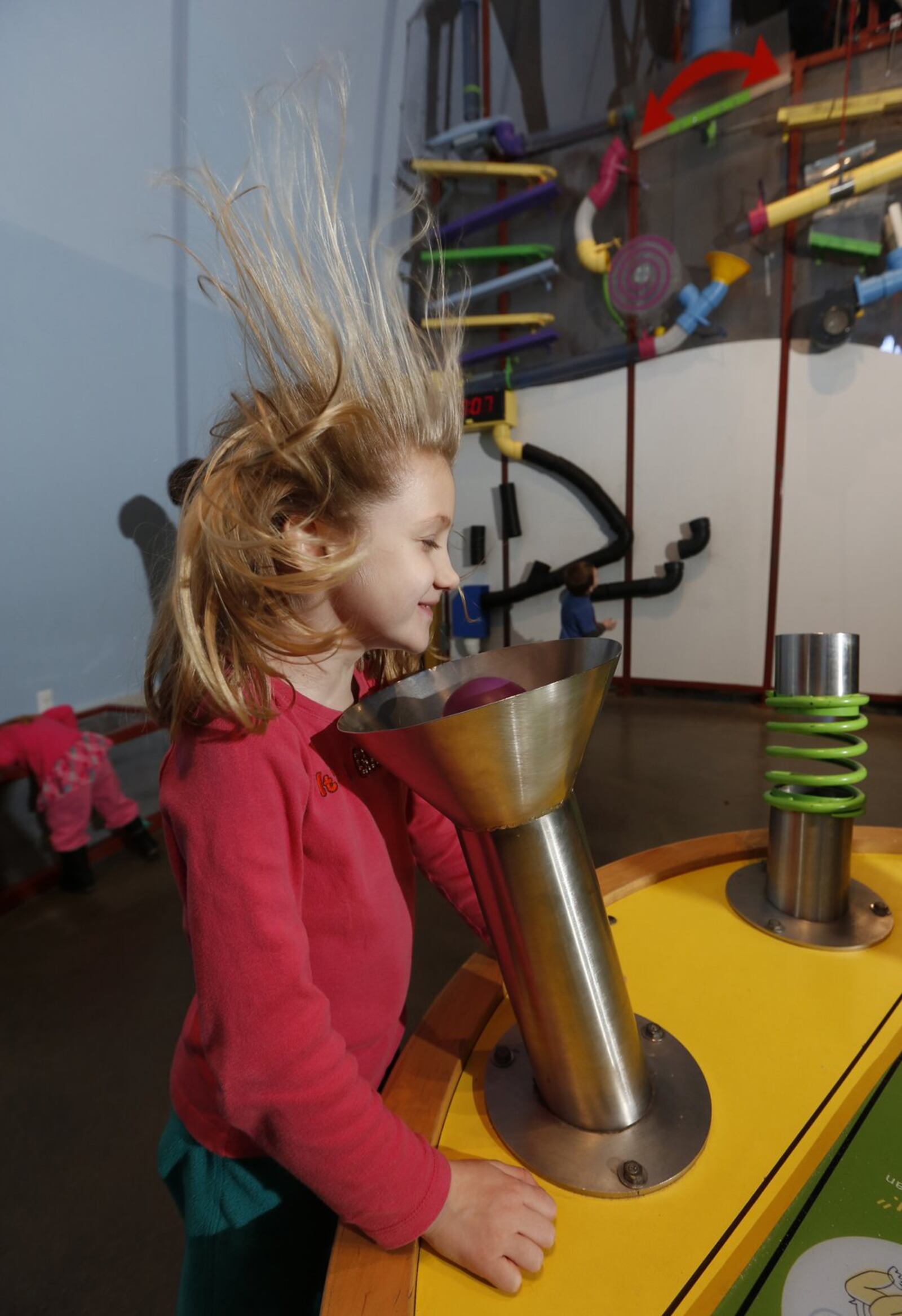 This child has a blast visiting a gadgets exhibit at COSI in Columbus. TOM DODGE/THE COLUMBUS DISPATCH