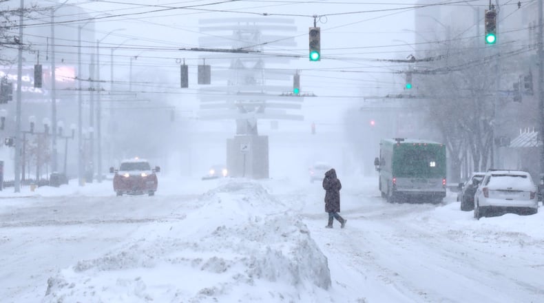 Downtown Dayton is almost empty in the snow Monday, Jan. 6, 2025. BILL LACKEY/STAFF