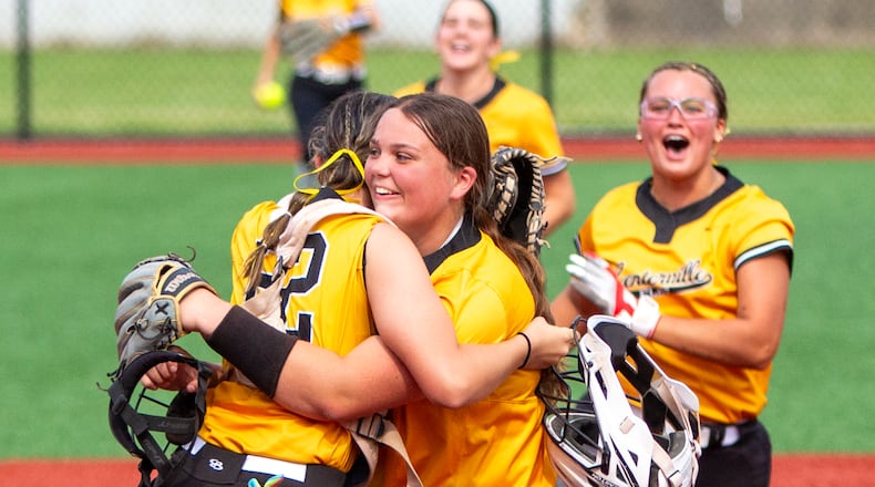 Centerville pitcher Caitlyn Belcher and catcher Riley Bakan celebrate Saturday's state semifinal in Akron win as second baseman Chayse Adkins and shortstop Natalie Carr run to join in. Jeff Gilbert/CONTRIBUTED
