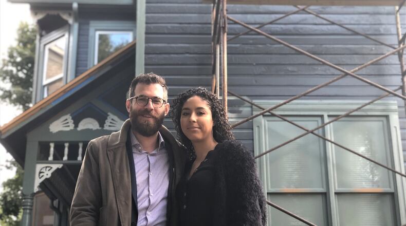 Marshall Weil and Gisselle Pereira purchased a home in Wright Dunbar Village earlier this year. The couple strongly encouraged their good friends Michael and Heather Allen to house hunt in the neighborhood. The Allens and Weil and Pereira now live one block apart. CORNELIUS FROLIK / STAFF
