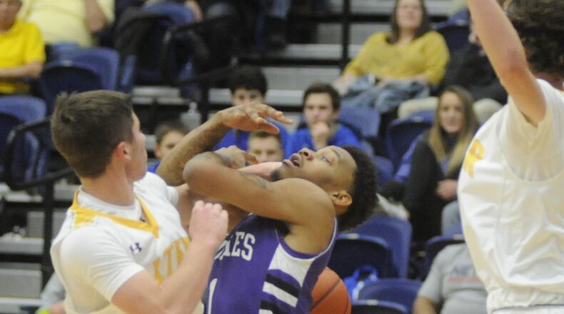 Middletown’s Nelson Rutledge (center) is fouled by Alter’s Robby Ruffolo. Alter defeated Middletown 48-44 in Day 4 of the Premier Health Flyin’ to the Hoop at Trent Arena in Kettering on Sunday, Jan. 16, 2017. MARC PENDLETON / STAFF