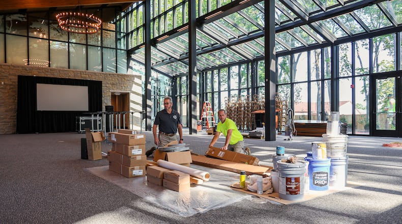 Centerville City Engineer Jim Brinegar (left) helps Andrew Rapp of Brumbaugh Construction unpack materials at the newly-constructed event center at Benham's Grove on North Main Street in Centerville. Workers are still putting finishing touches on the 6,000 square-feet facility, which has a capacity of 200 people. The event center has a main event space, outdoor terrace, bridal wing, groom's area and warming kitchen. BRYANT BILLING / STAFF