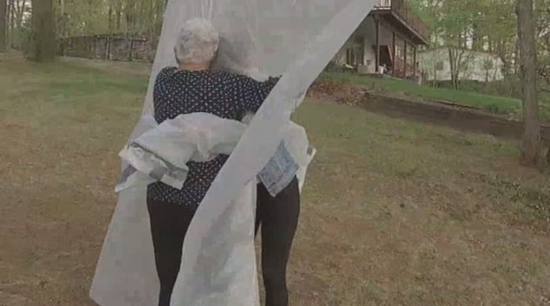 A Massachusetts family created a plastic “hug curtain” to safely embrace their grandparents in quarantine. (Boston25News.com/Boston25News.com)