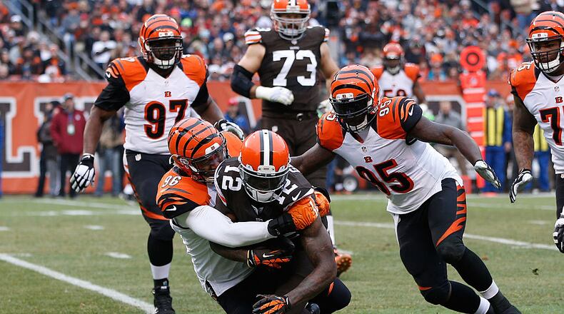 CLEVELAND, OH - DECEMBER 14: Josh Gordon #12 of the Cleveland Browns gets tackled by Carlos Dunlap #96 and Wallace Gilberry #95 of the Cincinnati Bengals during the second quarter at FirstEnergy Stadium on December 14, 2014 in Cleveland, Ohio. (Photo by Joe Robbins/Getty Images)