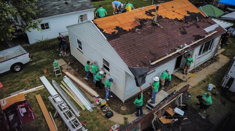 Volunteers from Shiloh Church and corporate partners reroof a house on Oneida Ave. in Harrison Twp. Thursday, Sept. 9, 2021. The house was damaged by the 2019 Memorial Day tornados. JIM NOELKER/STAFF