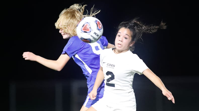 Cutline: Centerville High School junior midfielder Hailey Jeng watches the ball after colliding with Olentangy's Olivia Johnson during a Division I semifinal match on Tuesday night at Springfield High School. The Braves won 4-1. Michael Cooper/CONTRIBUTED