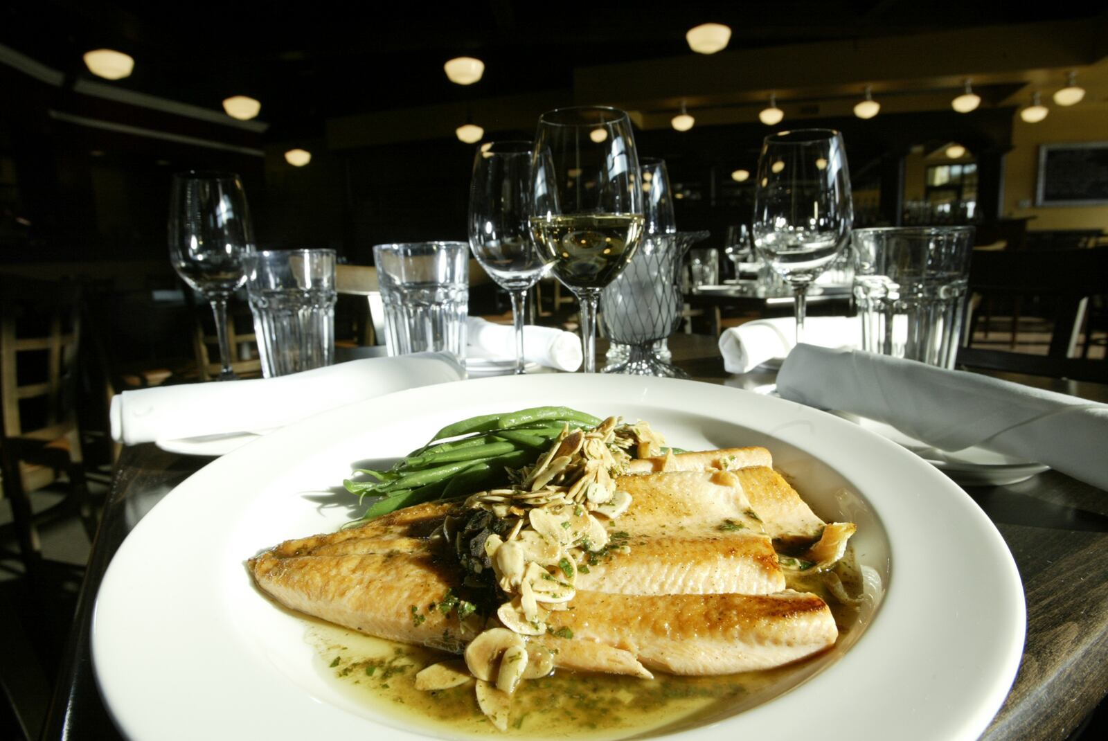 Trout Amandine is golden pan-seared trout with toasted almond brown butter, served with haricot vert for $19 with a Lioco Chardonnay Sonoma County 2006 $8 a glass or $40 a bottle from Rue Dumaine at 1061 Miamisburg-Centerville Road in Centerville. Rue Dumaine is open dinner 5-9:30 p.m. Tuesday-Thursday; 5-10 p.m. Friday and Saturday. Open for lunch 11:30 a.m.-2 p.m. Friday only beginning Jan. 4. Rue Dumaine has an extensive wine list with over a 100 wines.
Staff Photo by Teesha McClam