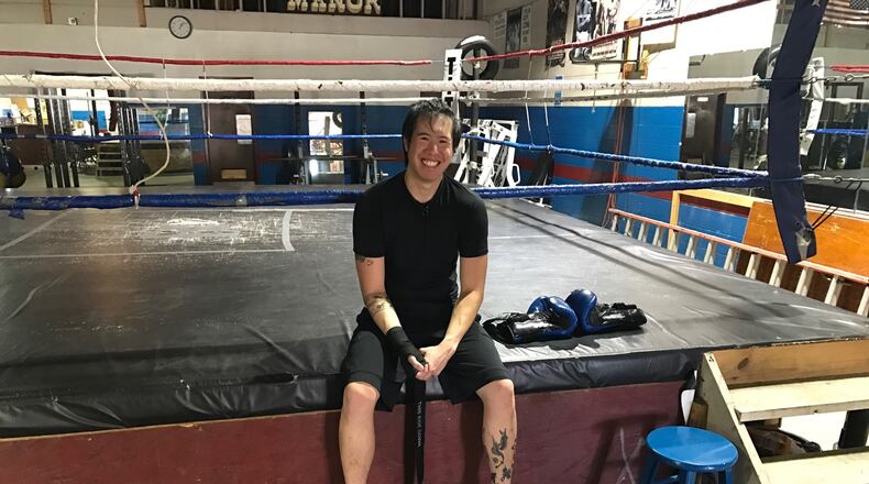 After a workout, Tommy Nguyen sits on the ring apron inside Drake’s Downtown Gym. Tom Archdeacon/STAFF