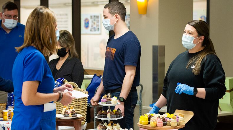 Nurses and medical technicians from the Wright-Patterson Medical Center go through the line to get a special cupcake May 12 during Florence Nightingale’s Birthday Celebration held as part of Nurse and Medical Technician Appreciation Week. Several events were held throughout the week to show appreciation for the nurses and medical technicians that work at the Wright-Patterson Medical Center. U.S. AIR FORCE PHOTO/WESLEY FARNSWORTH