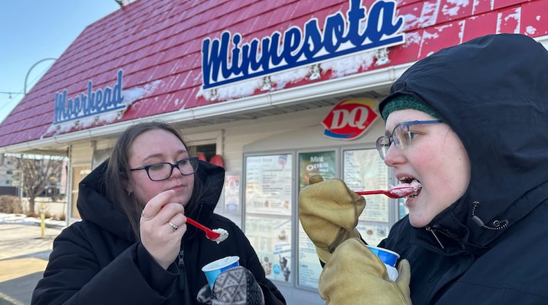 Koral Salisbury, left, and Ally Hoekstra eat ice cream treats Sunday, March 1, 2026, at the Dairy Queen in Moorhead, Minn. (AP Photo/Jack Dura)